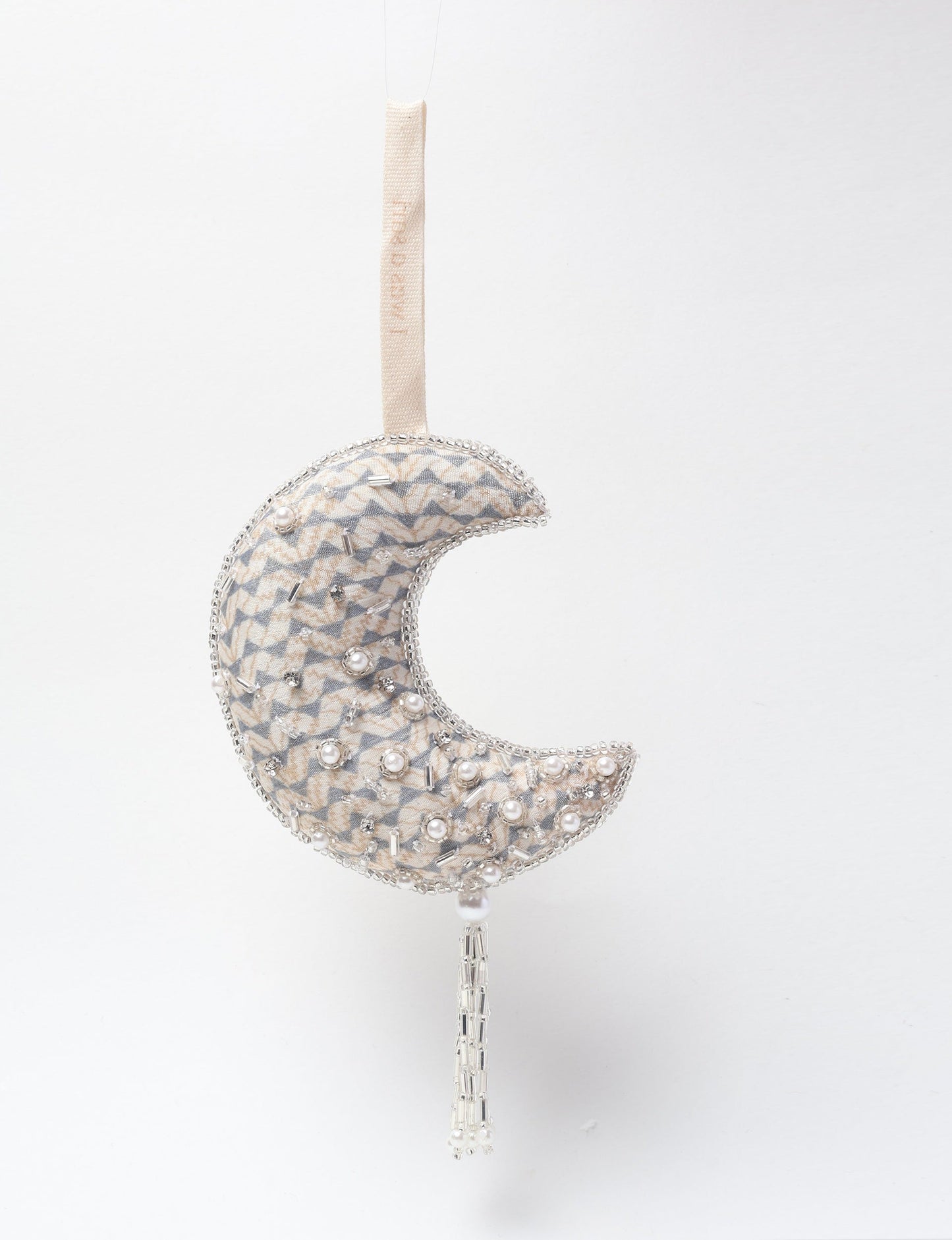 Crescent moon ornament made from recycled clothing, featuring fair trade fashion, clothes made from recycled fabric, and upcycled garments with elegant silver embellishments and tassel, ideal for those who value climate neutral clothing and recycled sustainable fashion.