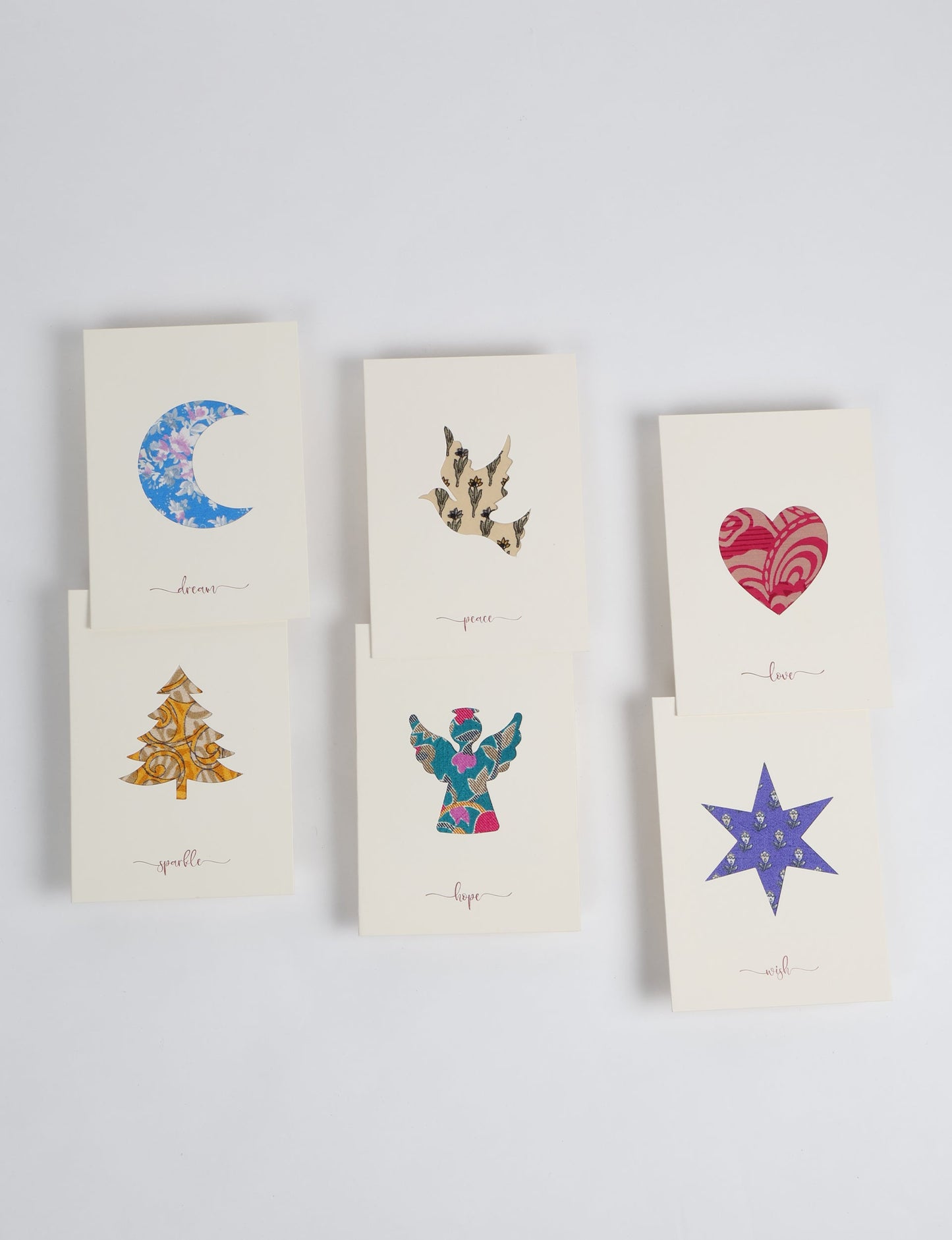 Folded greeting card set of 6 made from recycled sari scraps, symbolising Wish, Hope, Sparkle, Love, Peace, and Dream — beautifully designed with repurposed clothing textiles, upcycled garments, circular fashion inspiration, and fair trade fashion aesthetics, reflecting environmentally friendly clothing values.