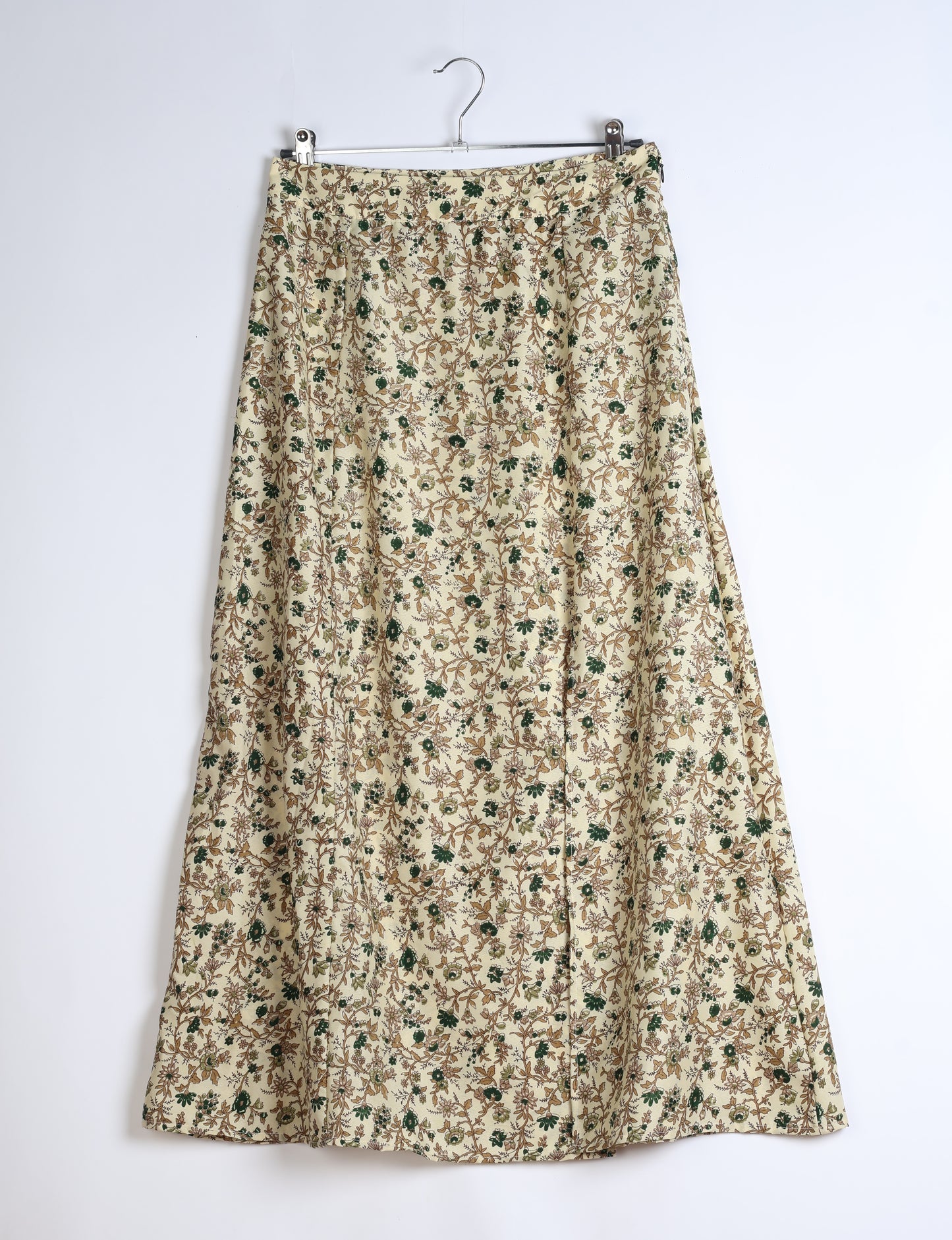 Midi A-line skirt with front slit, fitted waistband, concealed side closure, and below mid-calf length silhouette.