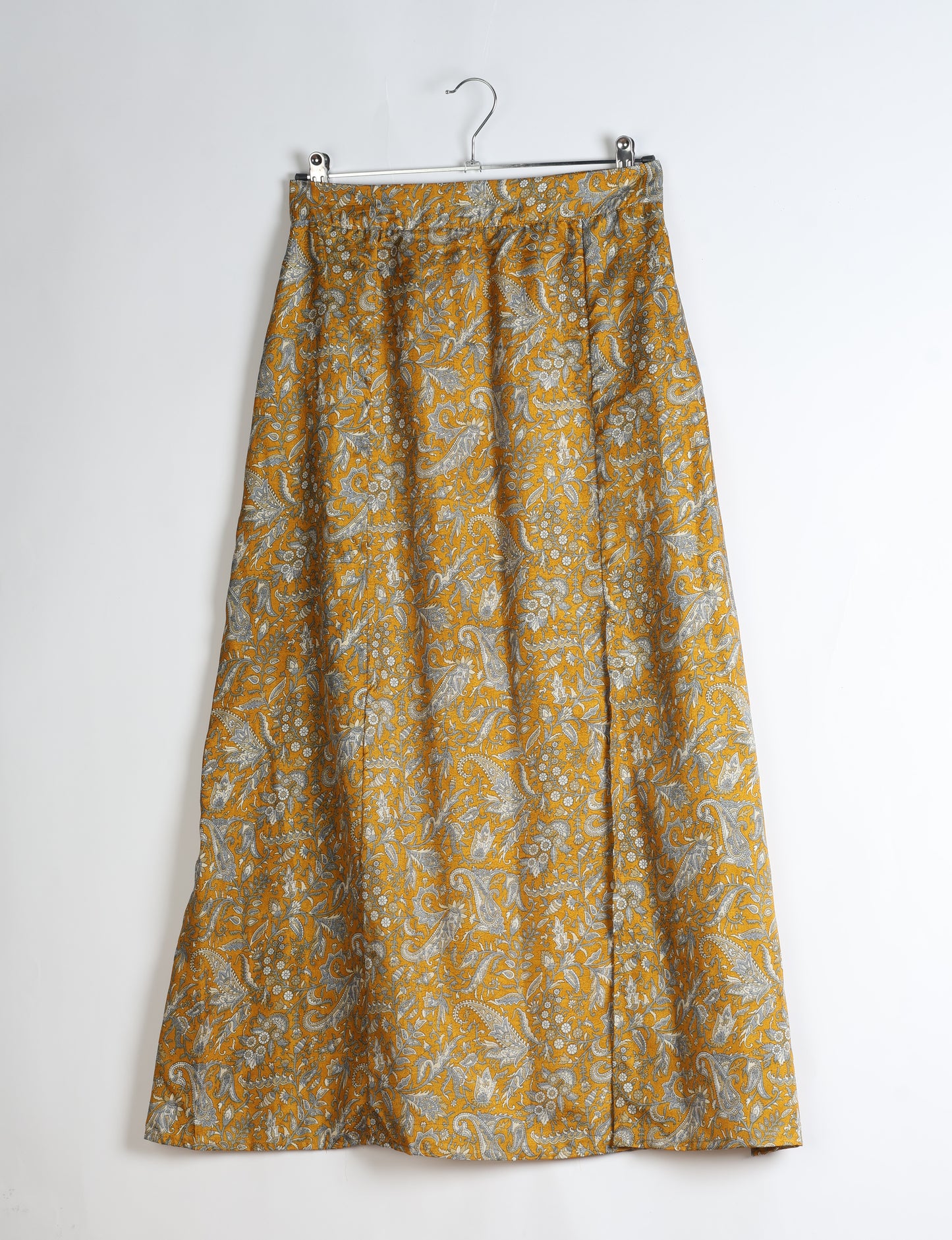 Midi A-line skirt with front slit, fitted waistband, concealed side closure, and below mid-calf length silhouette.