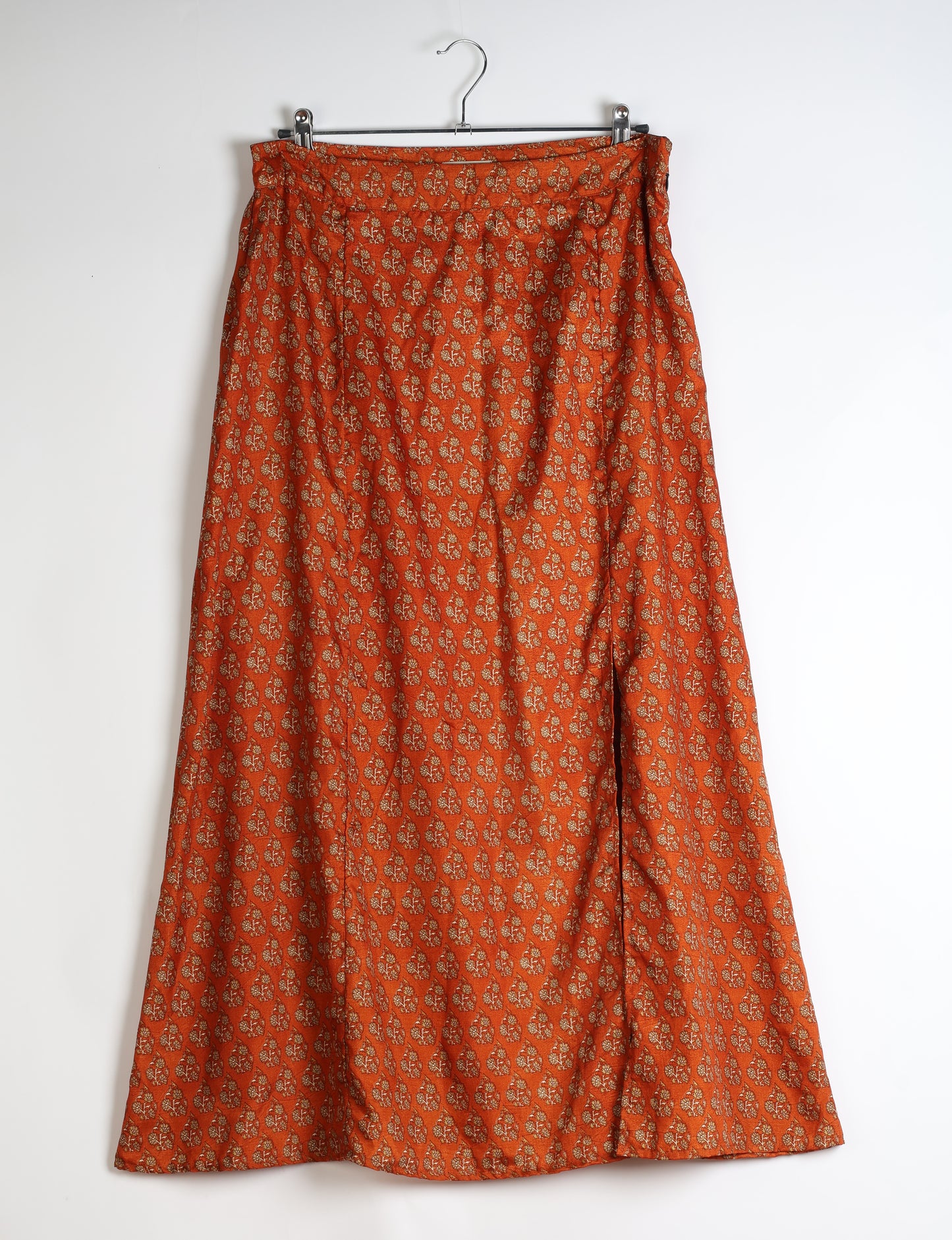 Midi A-line skirt with front slit, fitted waistband, concealed side closure, and below mid-calf length silhouette.