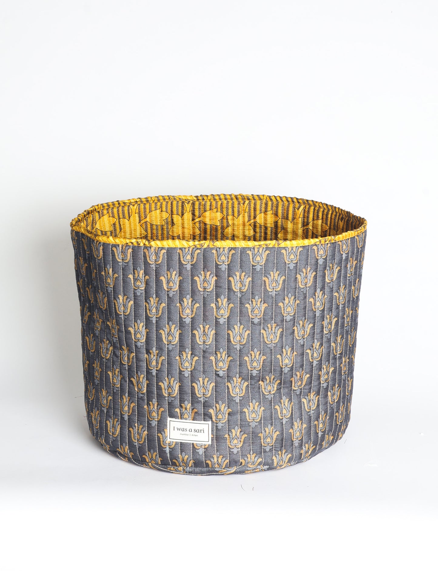 Quilted storage basket in a soft cylindrical shape, available in S, M, L, and XL sizes