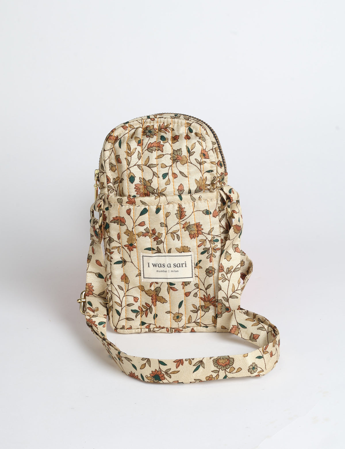 Compact quilted mobile bag featuring a padded rectangular silhouette, secure zip-top closure and adjustable crossbody strap for everyday use.