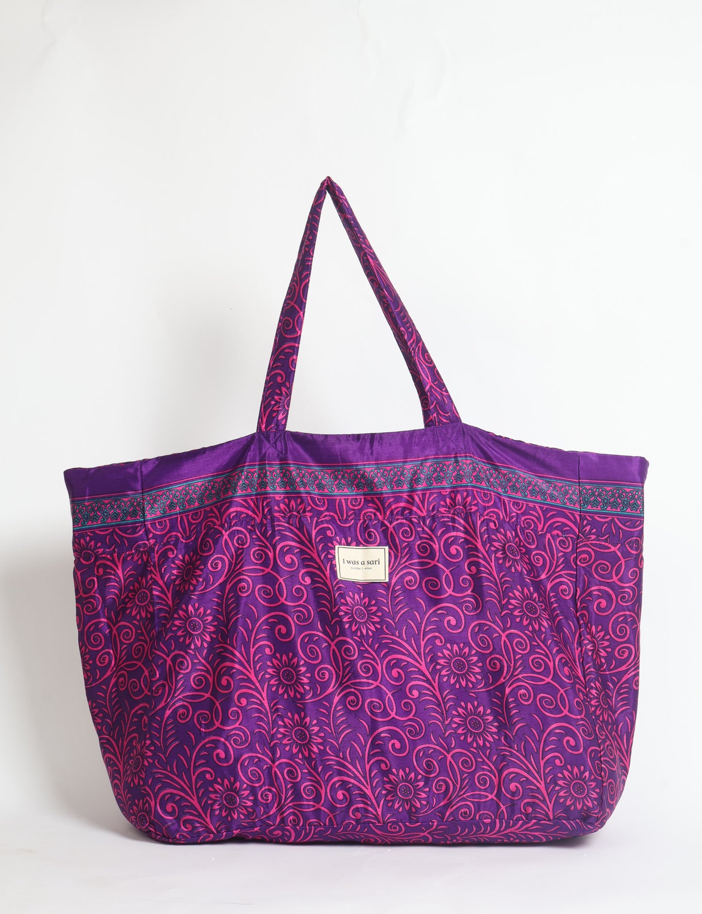 Large beach bag with a spacious rectangular design, wide top opening, and comfortable shoulder handles for carrying daily and travel essentials.