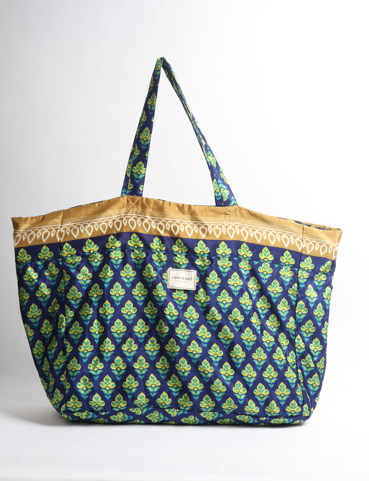 Large beach bag with a spacious rectangular design, wide top opening, and comfortable shoulder handles for carrying daily and travel essentials.
