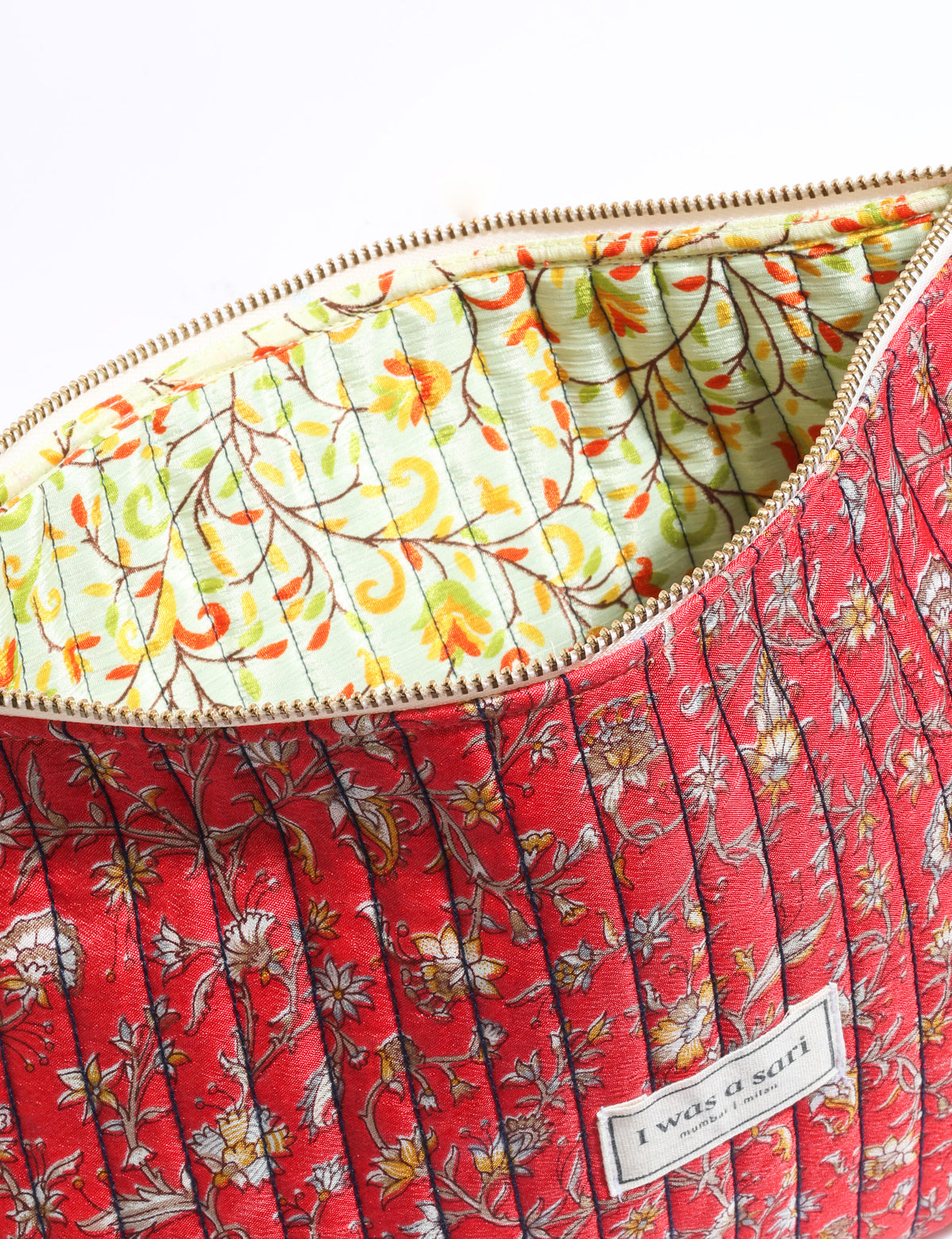 Quilted zipper pouch with tassel trim, available in three sizes for organising everyday essentials.