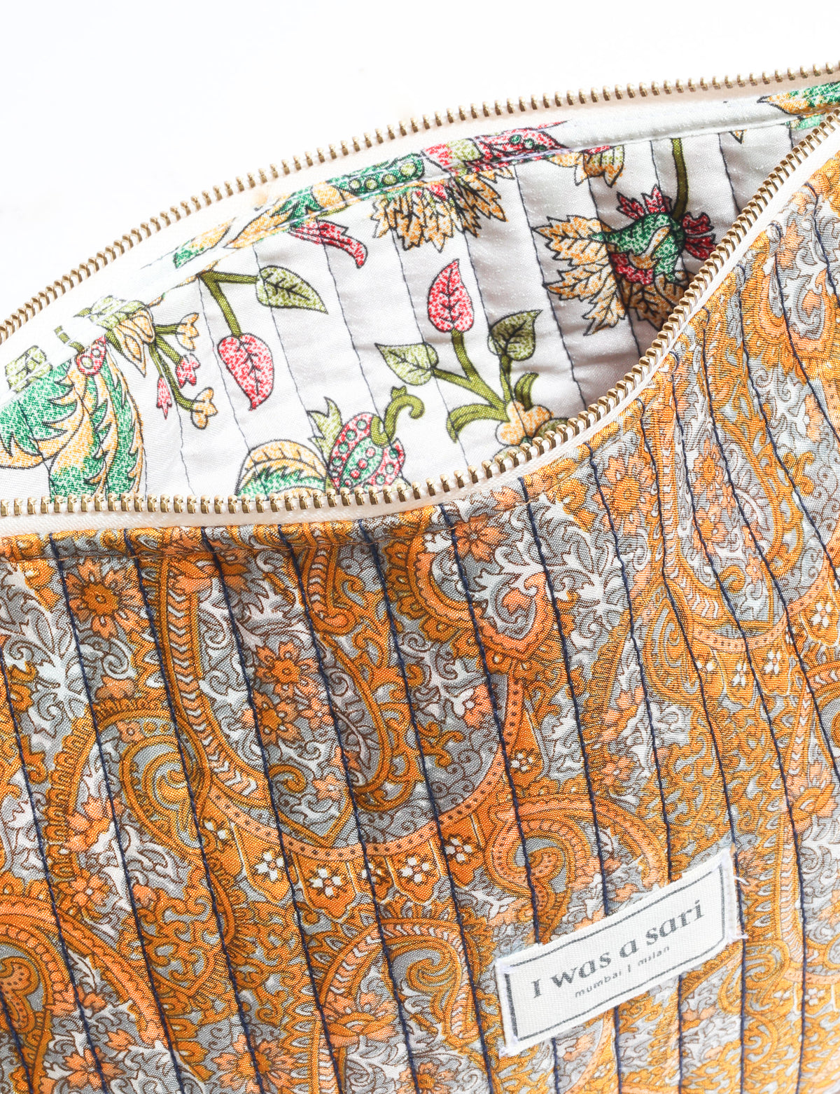 Quilted zipper pouch with tassel trim, available in three sizes for organising everyday essentials.