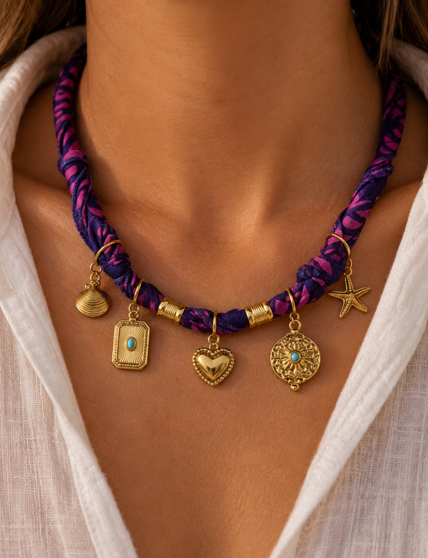 Bandana necklace with gold-plated charms, adjustable tie-back design, stainless steel hardware, handmade statement necklace, sustainable fashion accessory.