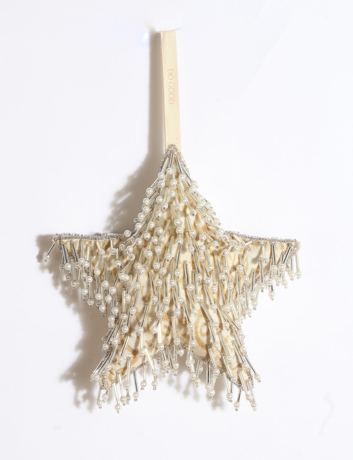 Silver star Christmas ornament made from upcycled ivory and grey saris with silver embroidery, pearls, sequins, and beads.
