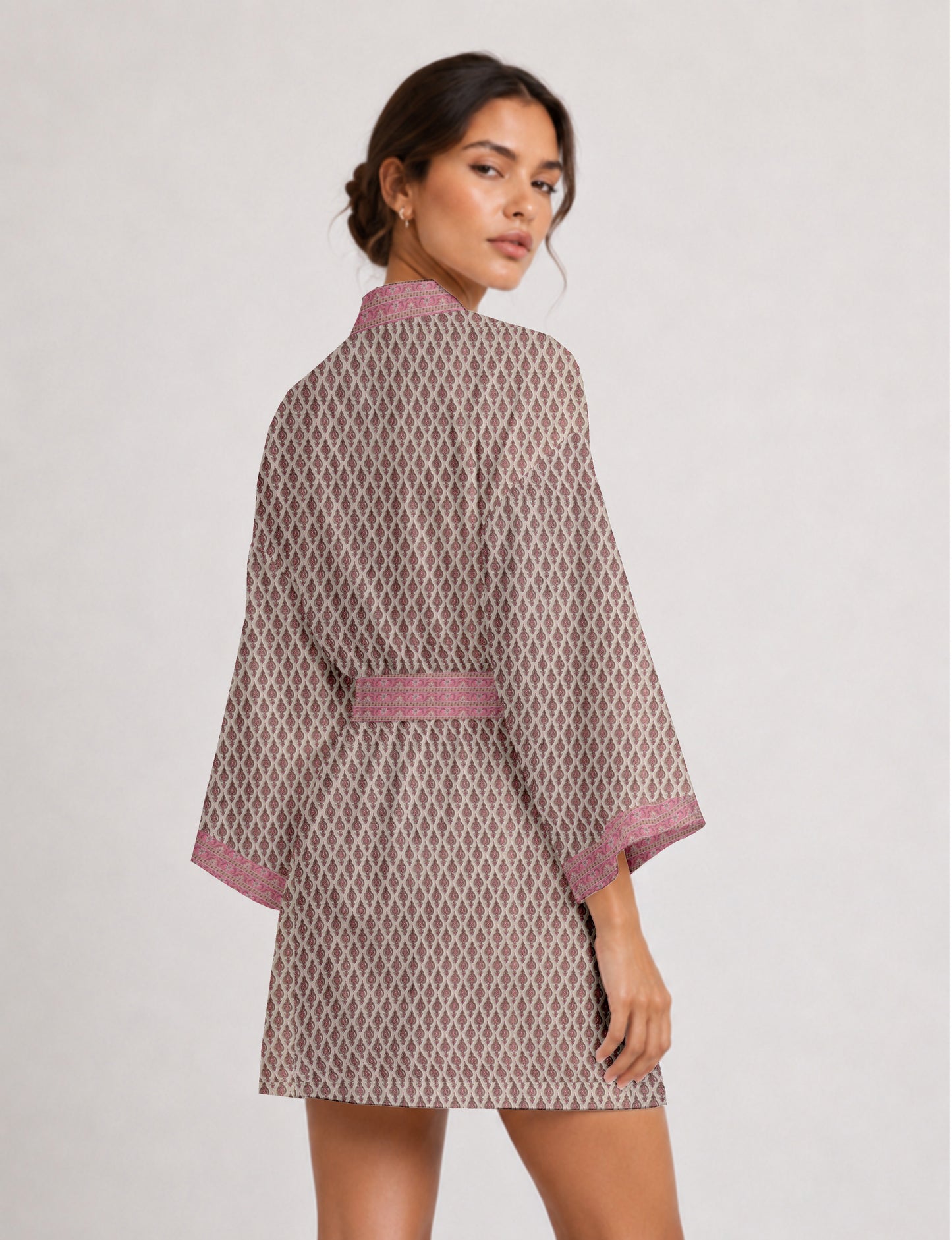 Short kimono robe with wrap front, V-neckline, wide sleeves, waist tie, and concealed skort detail.