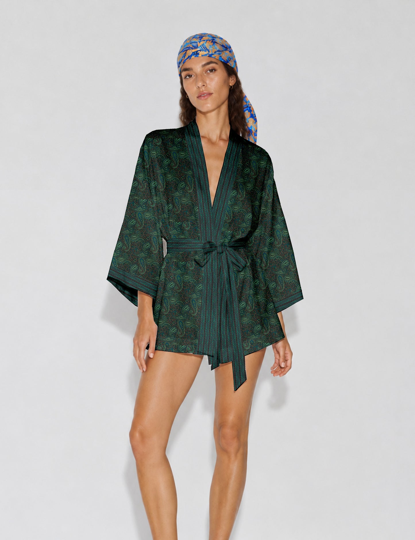 Short kimono robe with wrap front, V-neckline, wide sleeves, waist tie, and concealed skort detail.