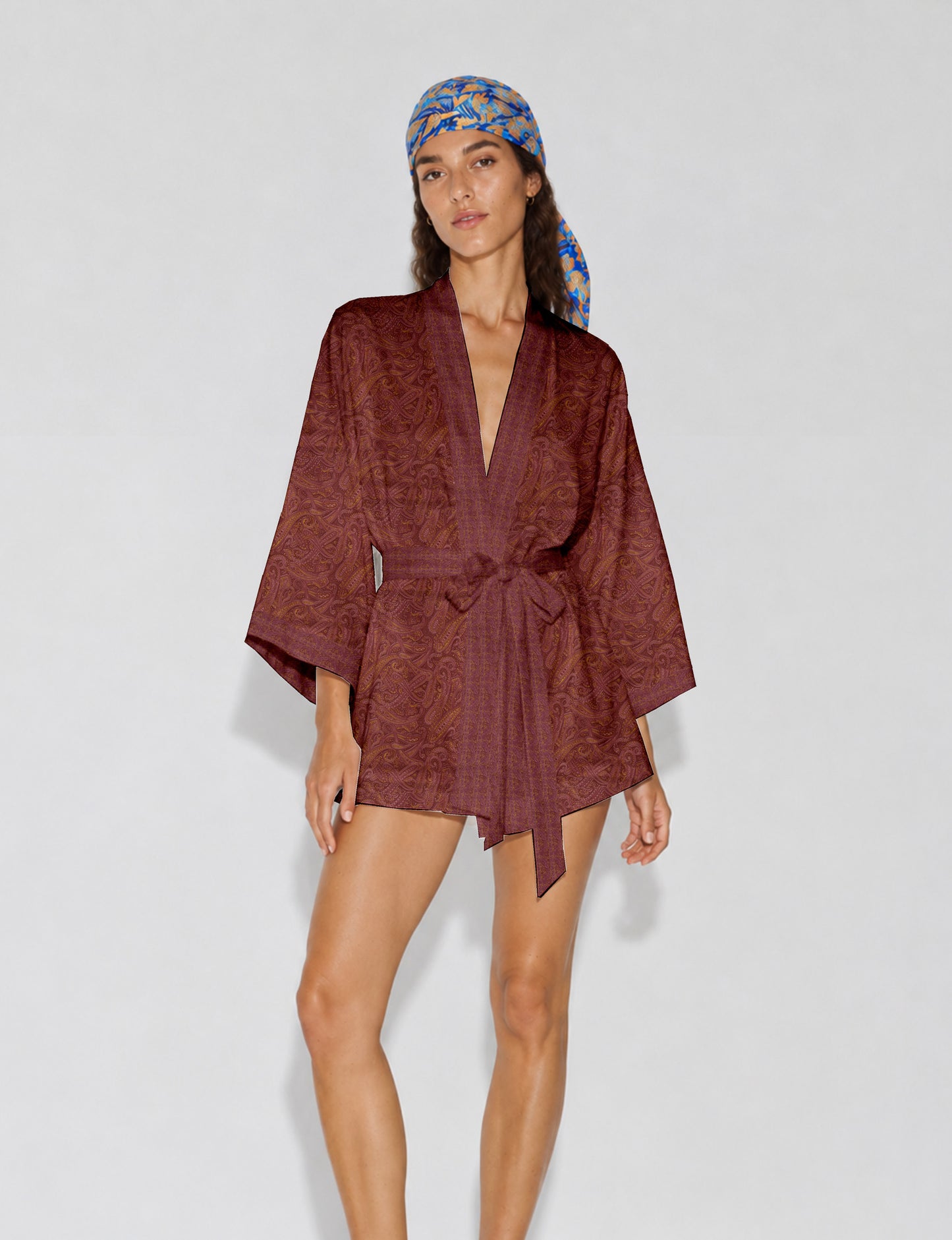 Short kimono robe with wrap front, V-neckline, wide sleeves, waist tie, and concealed skort detail.