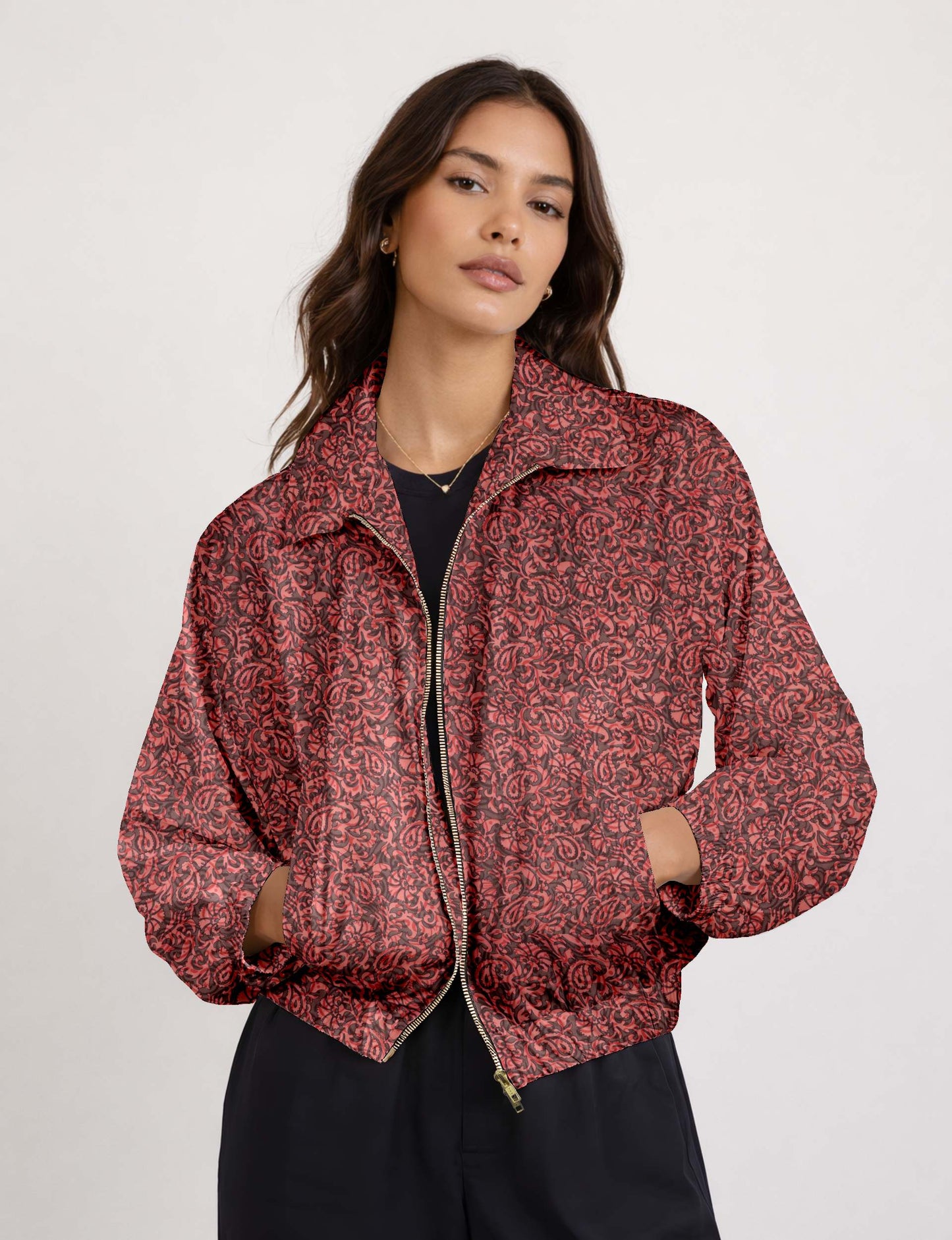 Woman wearing a yellow floral bomber jacket with front zipper, elastic cuffs, and side pockets, shown from front view