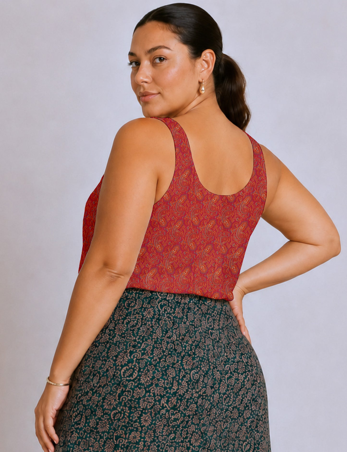 Women's sleeveless blouse with a relaxed straight fit, wide scoop neckline, deep scoop back, and hip-length silhouette.