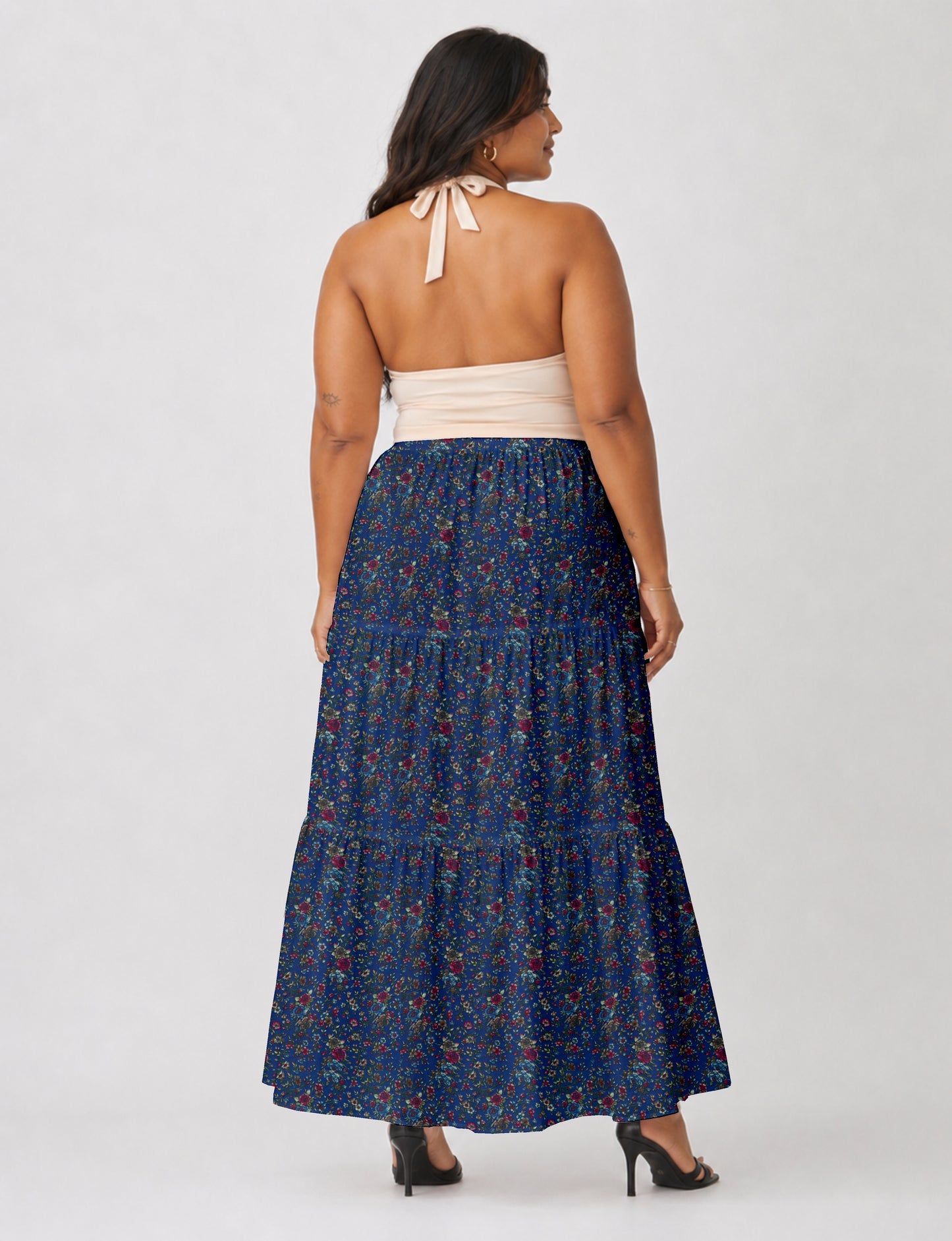 Midi tiered skirt with fitted waistband, soft knife pleats, flared silhouette, side seam pockets, and ankle-length hem
