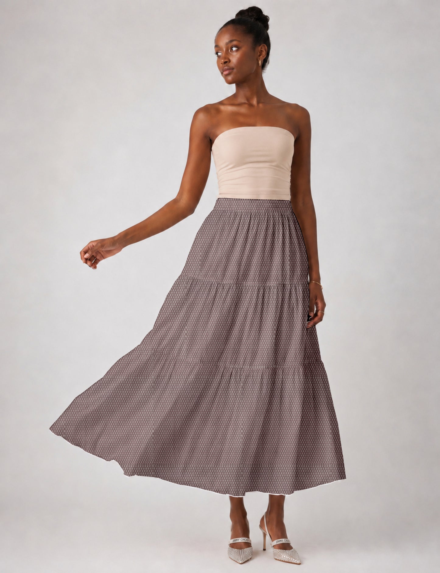 Midi tiered skirt with fitted waistband, soft knife pleats, flared silhouette, side seam pockets, and ankle-length hem