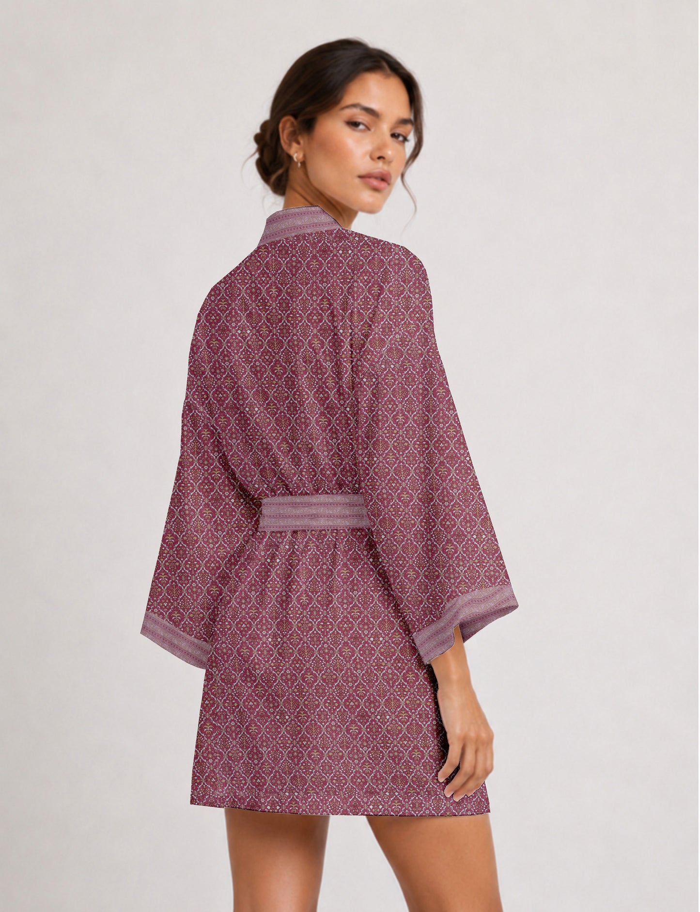 Short kimono robe with wrap front, V-neckline, wide sleeves, waist tie, and concealed skort detail.
