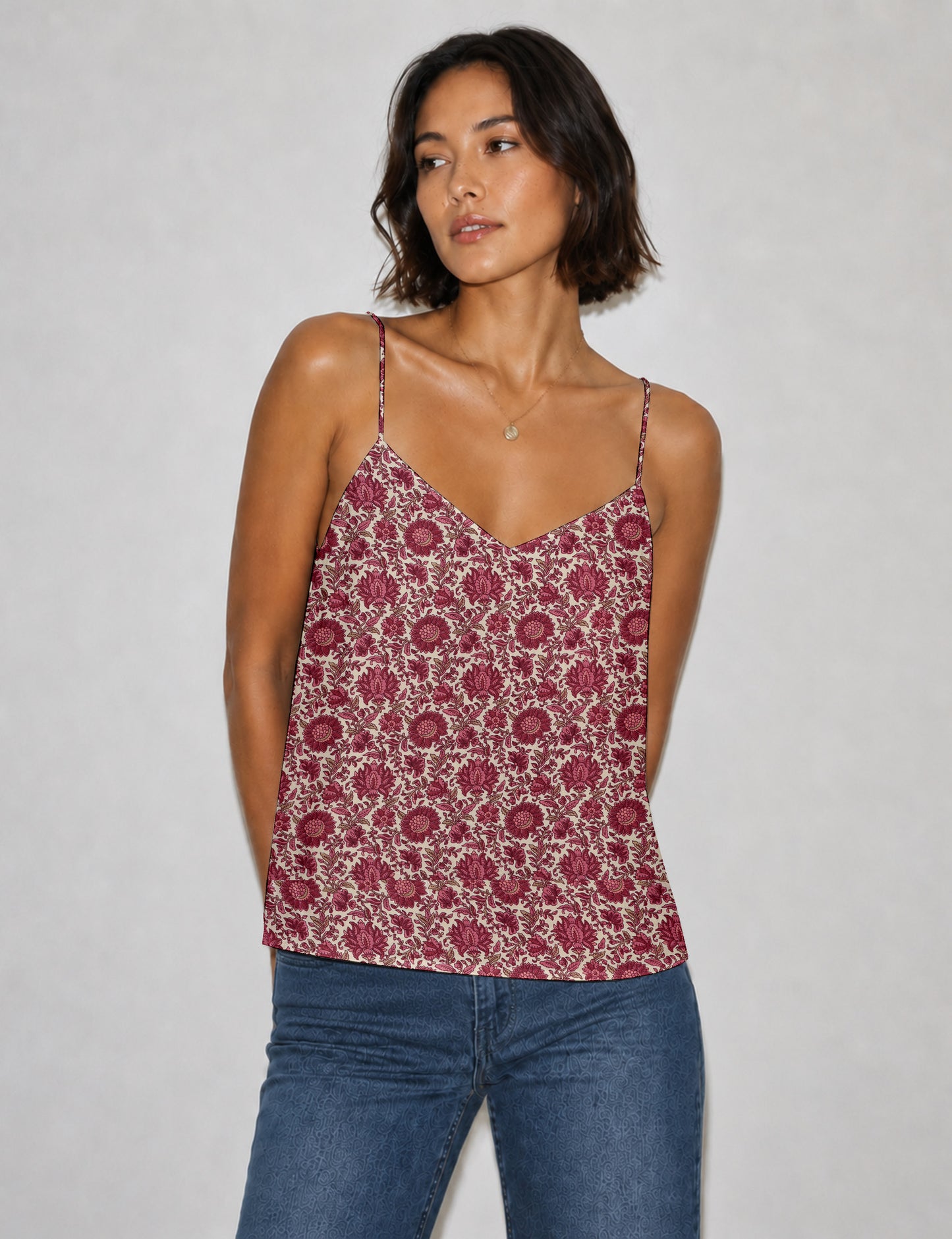 Women's sleeveless slip top with a relaxed straight fit, soft V-neckline, deep V-back, and delicate spaghetti straps.