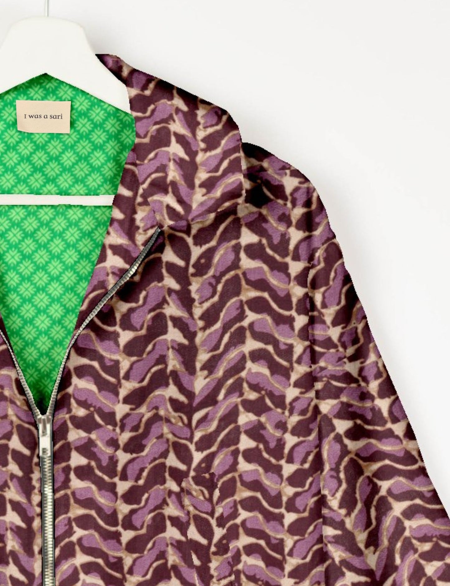 Upcycled Bomber Jacket made from recycled sari materials, featuring a cute cropped shape, elasticated hem and cuffs, and contrast sari print lining. Sustainable apparel promoting eco-friendly fashion and ethical clothing.