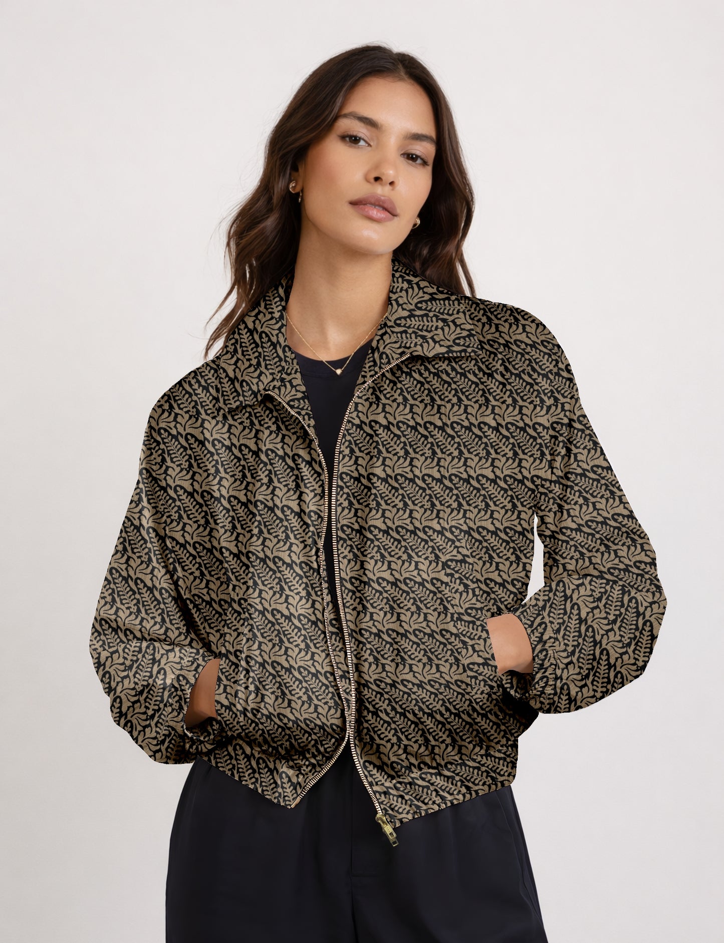 Women's cropped bomber jacket with twin metallic front zippers, welt pockets, elasticated hem and cuffs, and contrast sari print lining.