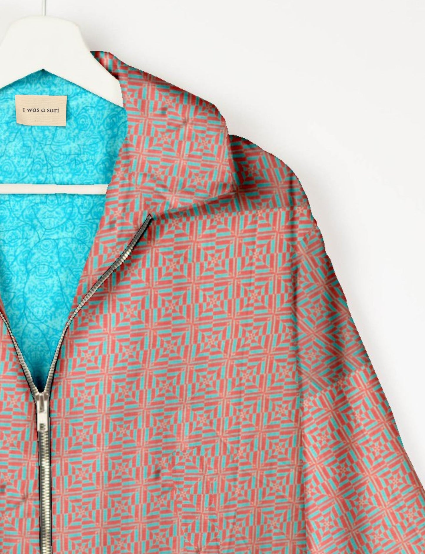 Upcycled Bomber Jacket made from recycled sari materials, featuring a cute cropped shape, elasticated hem and cuffs, and contrast sari print lining. Sustainable apparel promoting eco-friendly fashion and ethical clothing.