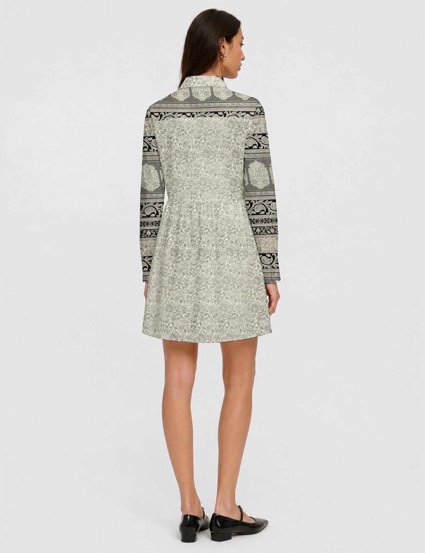 Short shirt dress with a relaxed A-line silhouette, point collar, partial button placket, gathered waist, side pockets, and full-length cuffed sleeves.