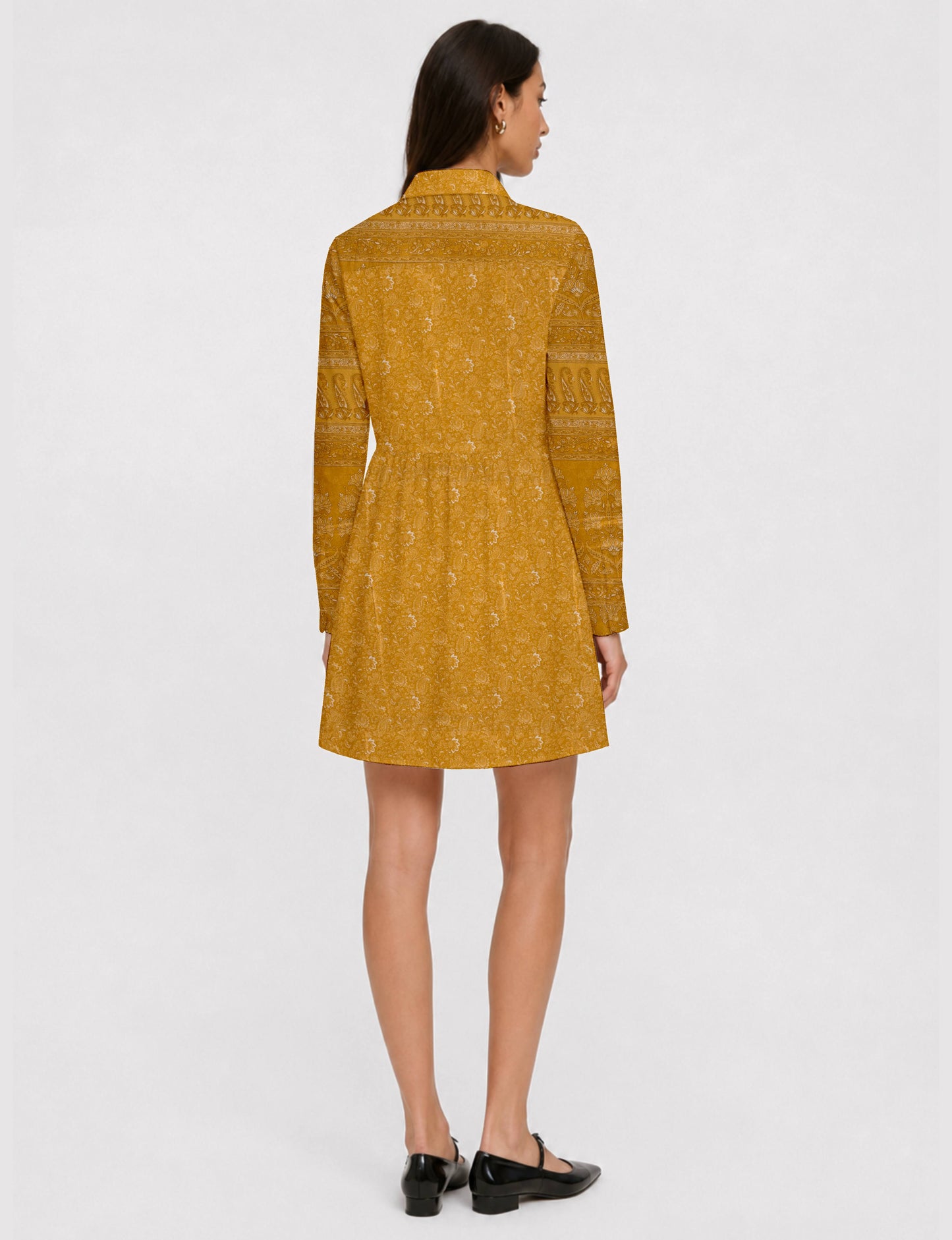 Short shirt dress with a relaxed A-line silhouette, point collar, partial button placket, gathered waist, side pockets, and full-length cuffed sleeves.