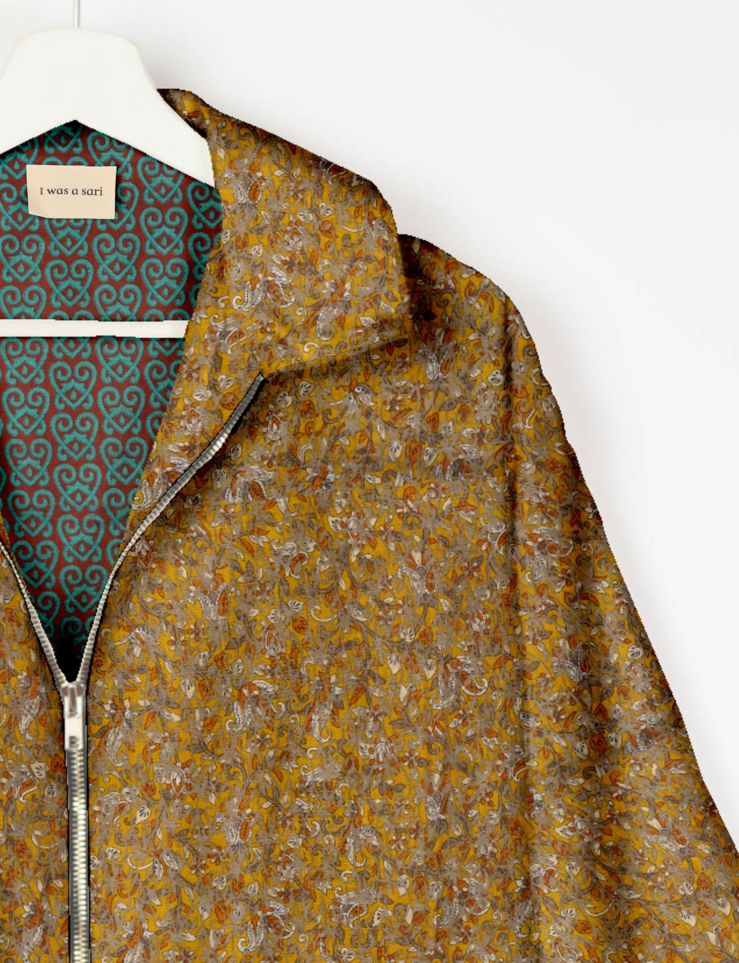 Upcycled Bomber Jacket made from recycled sari materials, featuring a cute cropped shape, elasticated hem and cuffs, and contrast sari print lining. Sustainable apparel promoting eco-friendly fashion and ethical clothing.