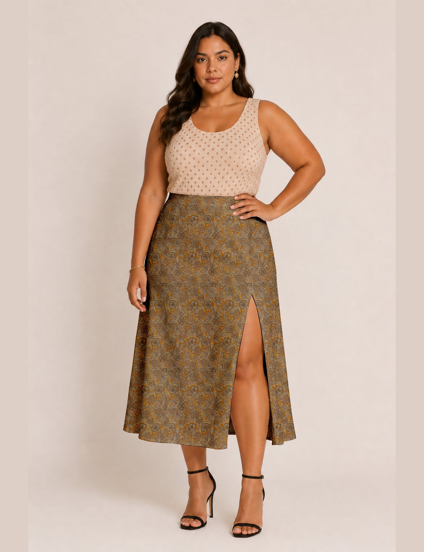Woman wearing a yellow and black micro patterned A-line skirt with front slit, paired with beige sleeveless top and black