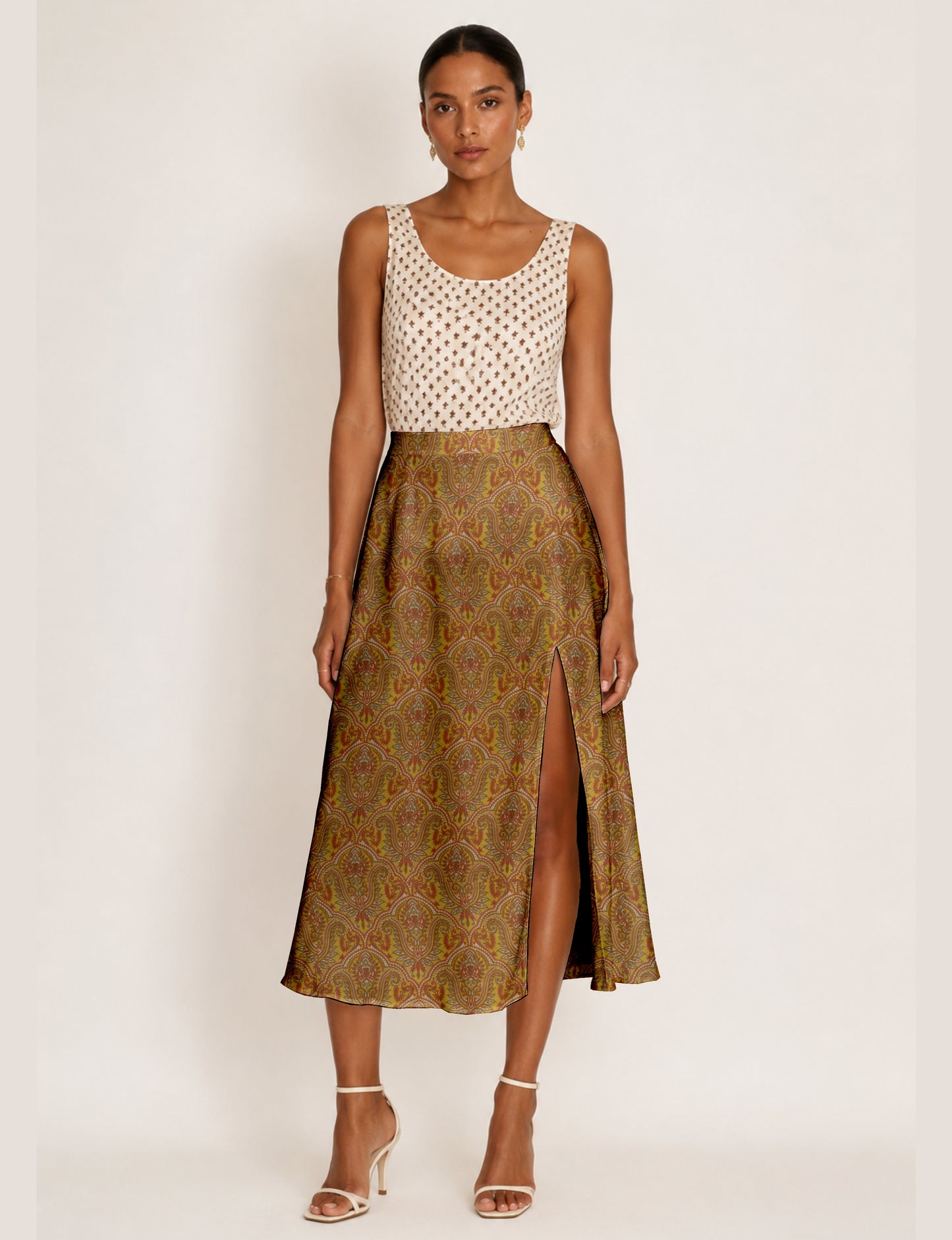 Midi A-line skirt with front slit, fitted waistband, concealed side closure, and below mid-calf length silhouette.