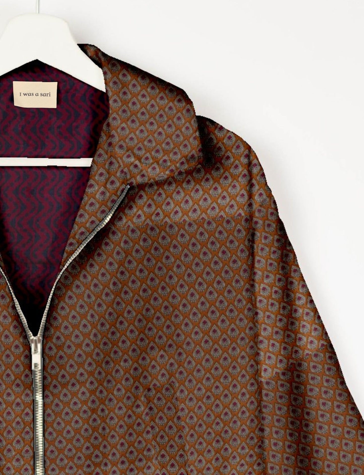 Upcycled Bomber Jacket made from recycled sari materials, featuring a cute cropped shape, elasticated hem and cuffs, and contrast sari print lining. Sustainable apparel promoting eco-friendly fashion and ethical clothing.