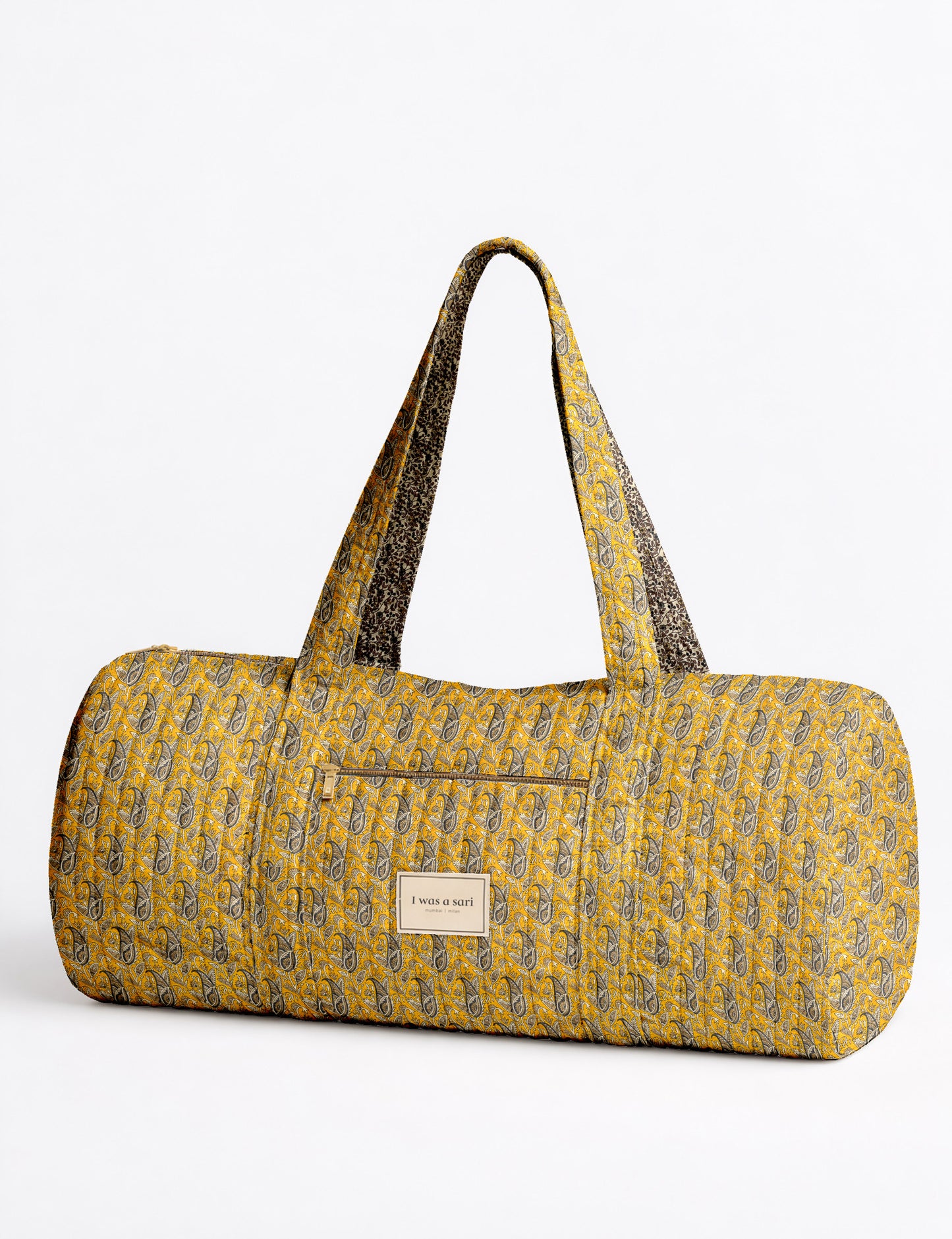 Quilted brown paisley bowling bag with gold zipper, floral interior lining, and interior key clip with label inside pocket