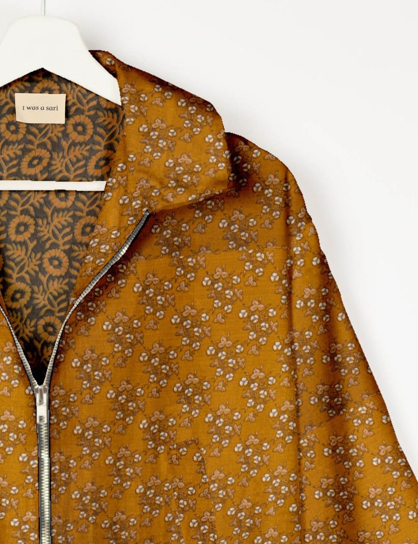 Upcycled Bomber Jacket made from recycled sari materials, featuring a cute cropped shape, elasticated hem and cuffs, and contrast sari print lining. Sustainable apparel promoting eco-friendly fashion and ethical clothing.