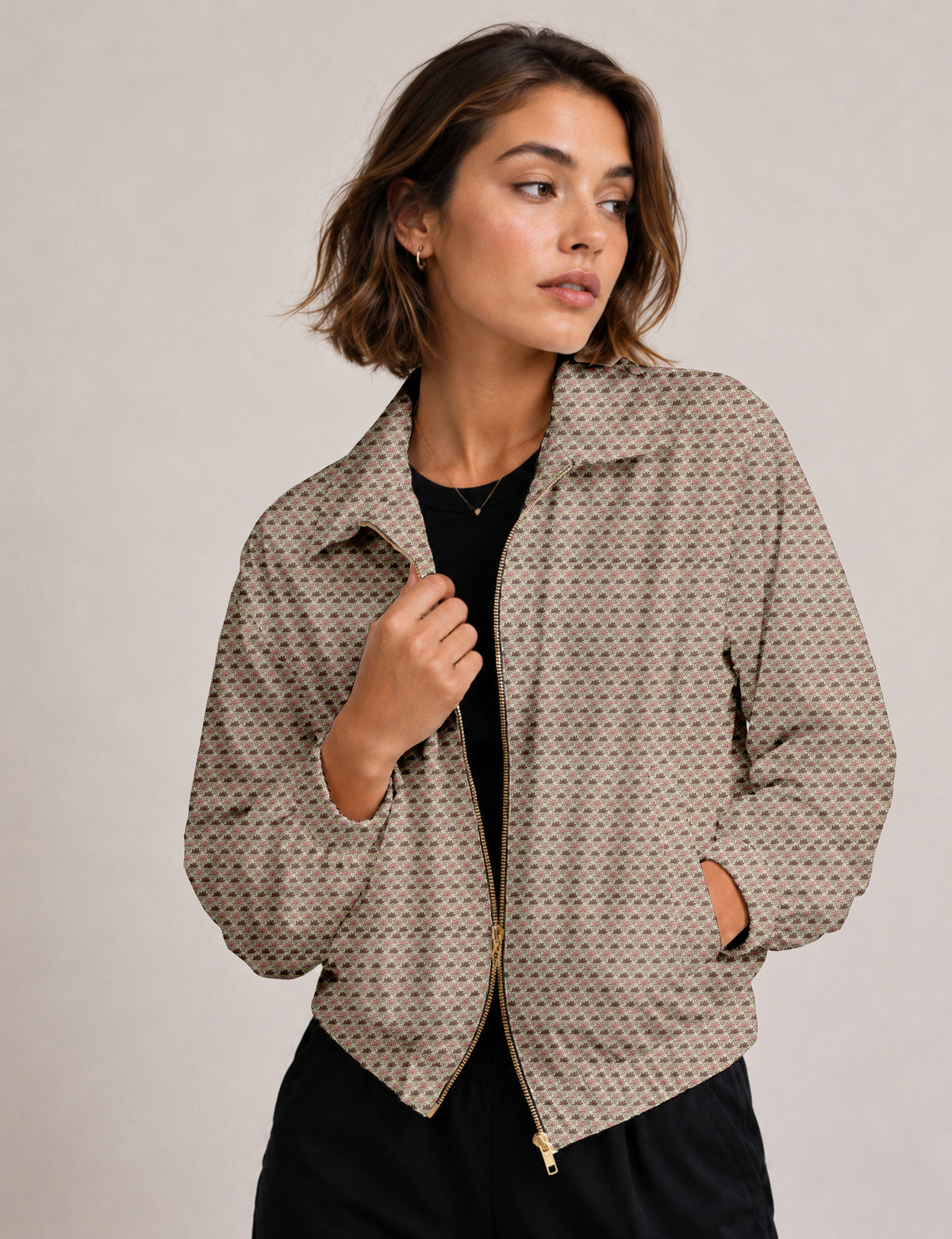 Woman wearing a yellow floral bomber jacket with front zipper, elastic cuffs, and side pockets, shown from front view