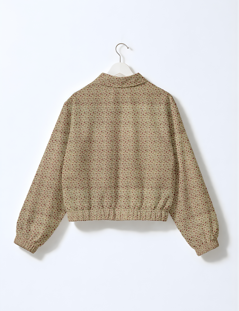 Beige floral bomber jacket with elastic cuffs and waistband, shown from back on white hanger against white background