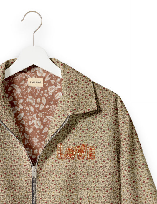 Love Bomber Jacket made from recycled fabric, featuring hand-stitched Aari embroidery. A unique piece of zero-waste clothing, part of the circular fashion movement. Designed with upcycled materials for a stylish yet environmentally friendly clothing choice.
