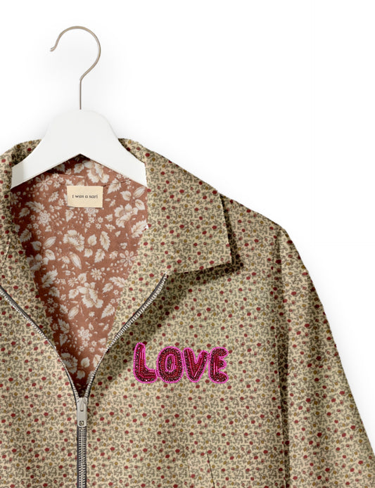 Love Bomber Jacket made from recycled fabric, featuring hand-stitched Aari embroidery. A unique piece of zero-waste clothing, part of the circular fashion movement. Designed with upcycled materials for a stylish yet environmentally friendly clothing choice.