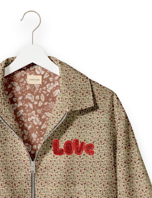 Love Bomber Jacket made from recycled fabric, featuring hand-stitched Aari embroidery. A unique piece of zero-waste clothing, part of the circular fashion movement. Designed with upcycled materials for a stylish yet environmentally friendly clothing choice.