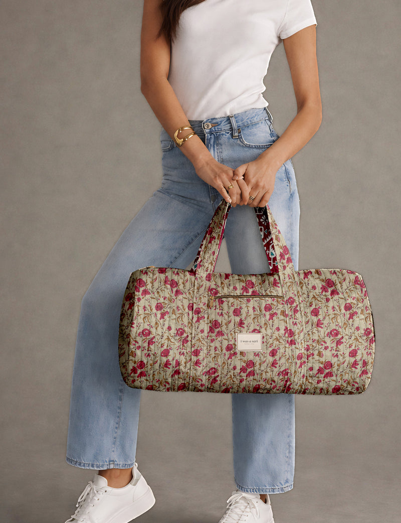 Brown paisley quilted bowling bag with dual handles, front zipper pocket, and "I was a sari" label on front side