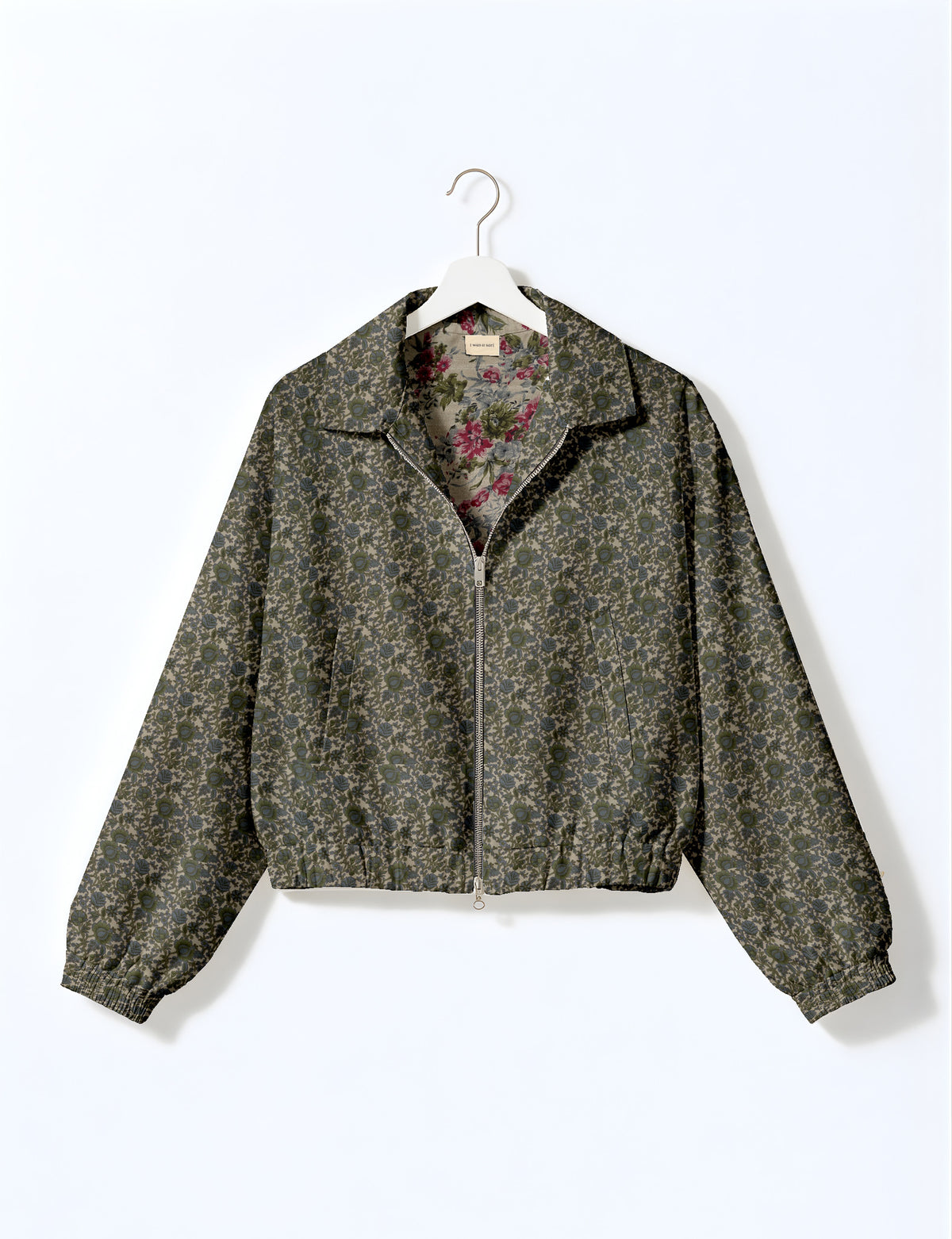 Woman wearing a yellow floral bomber jacket with front zipper, elastic cuffs, and side pockets, shown from front view
