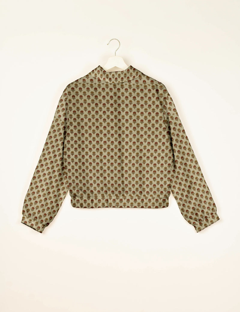 Beige bomber jacket with red and brown floral pattern, long sleeves, elastic cuffs and waistband, back view on hanger