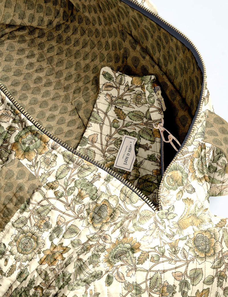 Quilted brown paisley bowling bag with gold zipper, floral interior lining, and interior key clip with label inside pocket