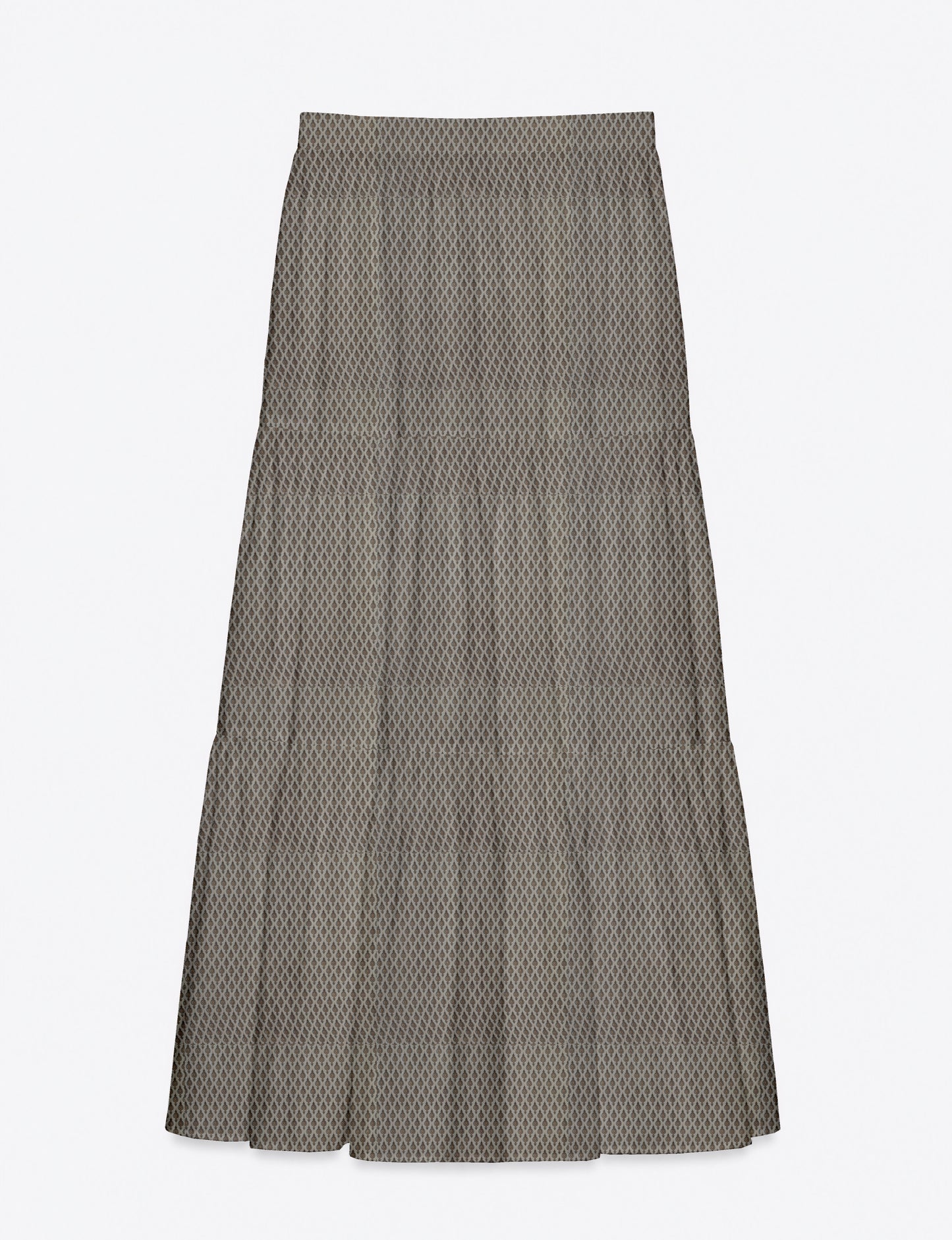 Woman wearing a yellow midi tiered skirt with a small geometric pattern, shown from the back, paired with beige top and