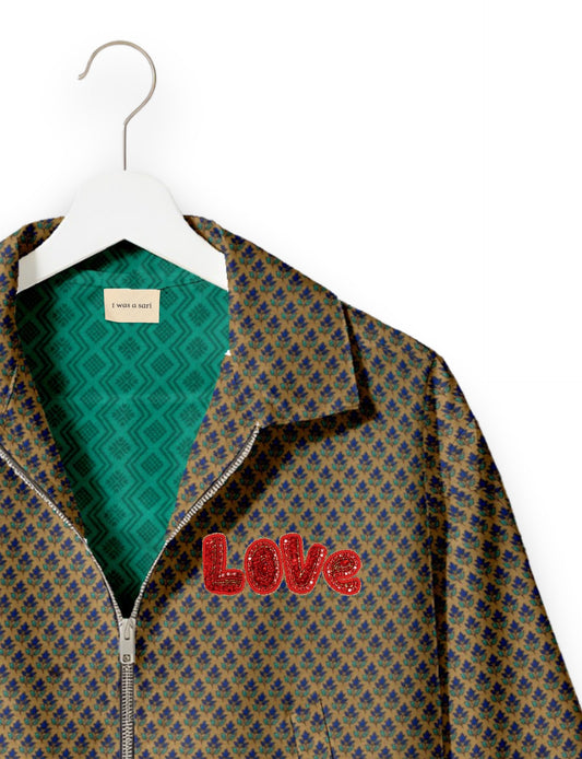 Love Bomber Jacket made from recycled fabric, featuring hand-stitched Aari embroidery. A unique piece of zero-waste clothing, part of the circular fashion movement. Designed with upcycled materials for a stylish yet environmentally friendly clothing choice.