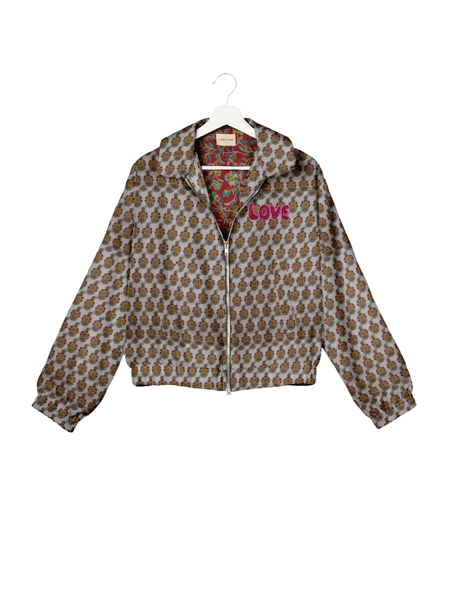 Love Bomber Jacket made from recycled fabric, featuring hand-stitched Aari embroidery. A unique piece of zero-waste clothing, part of the circular fashion movement. Designed with upcycled materials for a stylish yet environmentally friendly clothing choice.