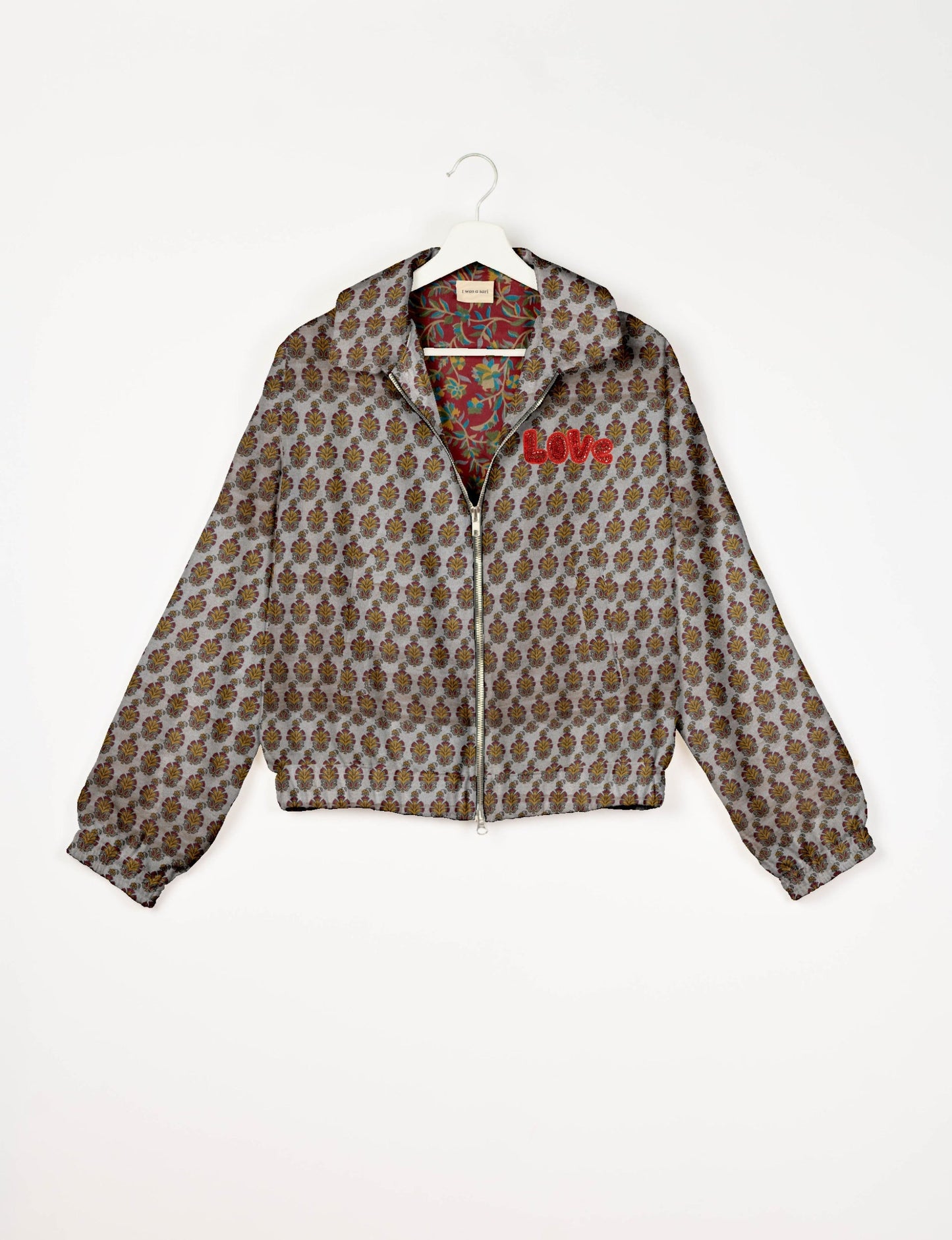 Love Bomber Jacket made from recycled fabric, featuring hand-stitched Aari embroidery. A unique piece of zero-waste clothing, part of the circular fashion movement. Designed with upcycled materials for a stylish yet environmentally friendly clothing choice.