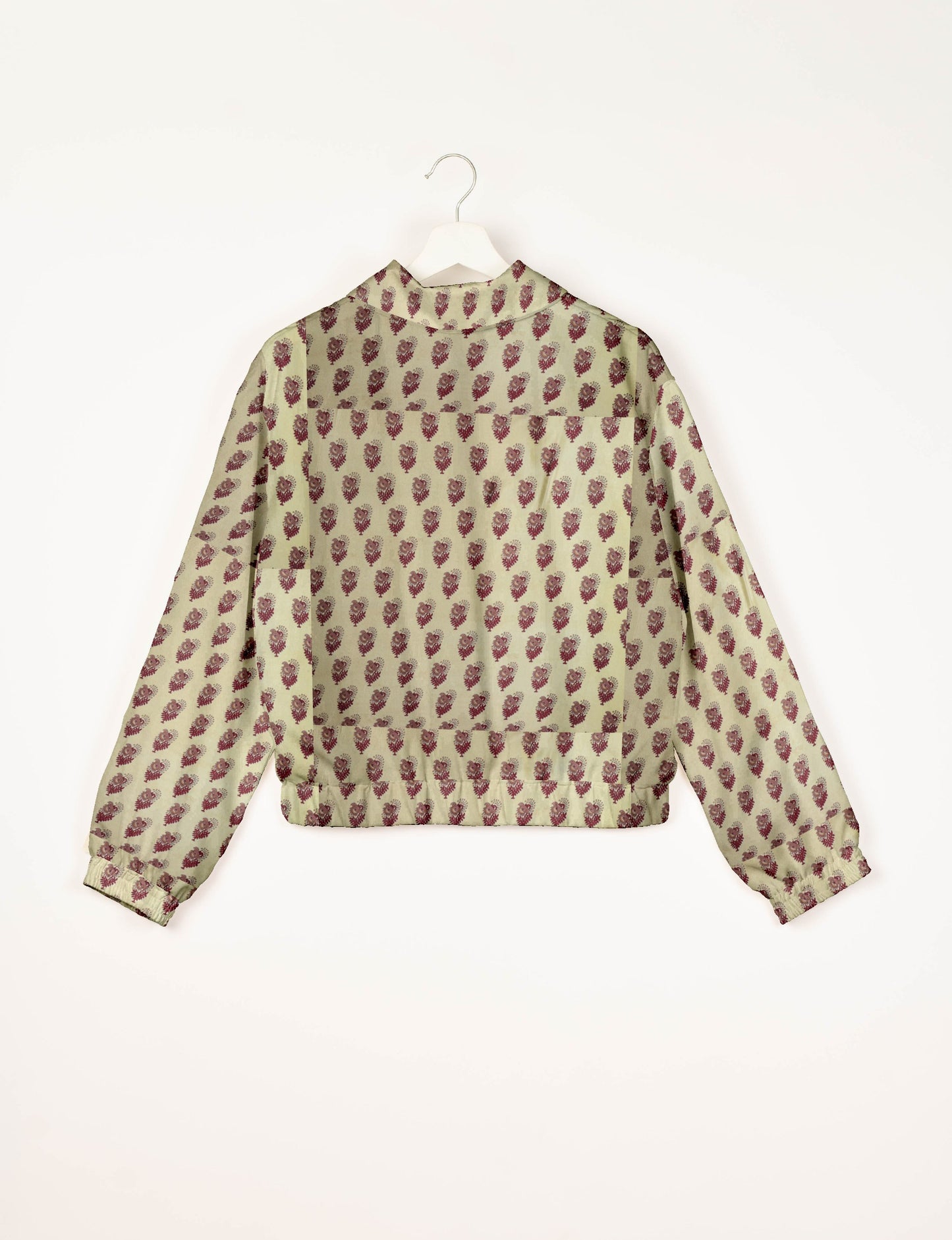 Beige bomber jacket with maroon leaf pattern, elastic cuffs, and back view on white hanger against white background