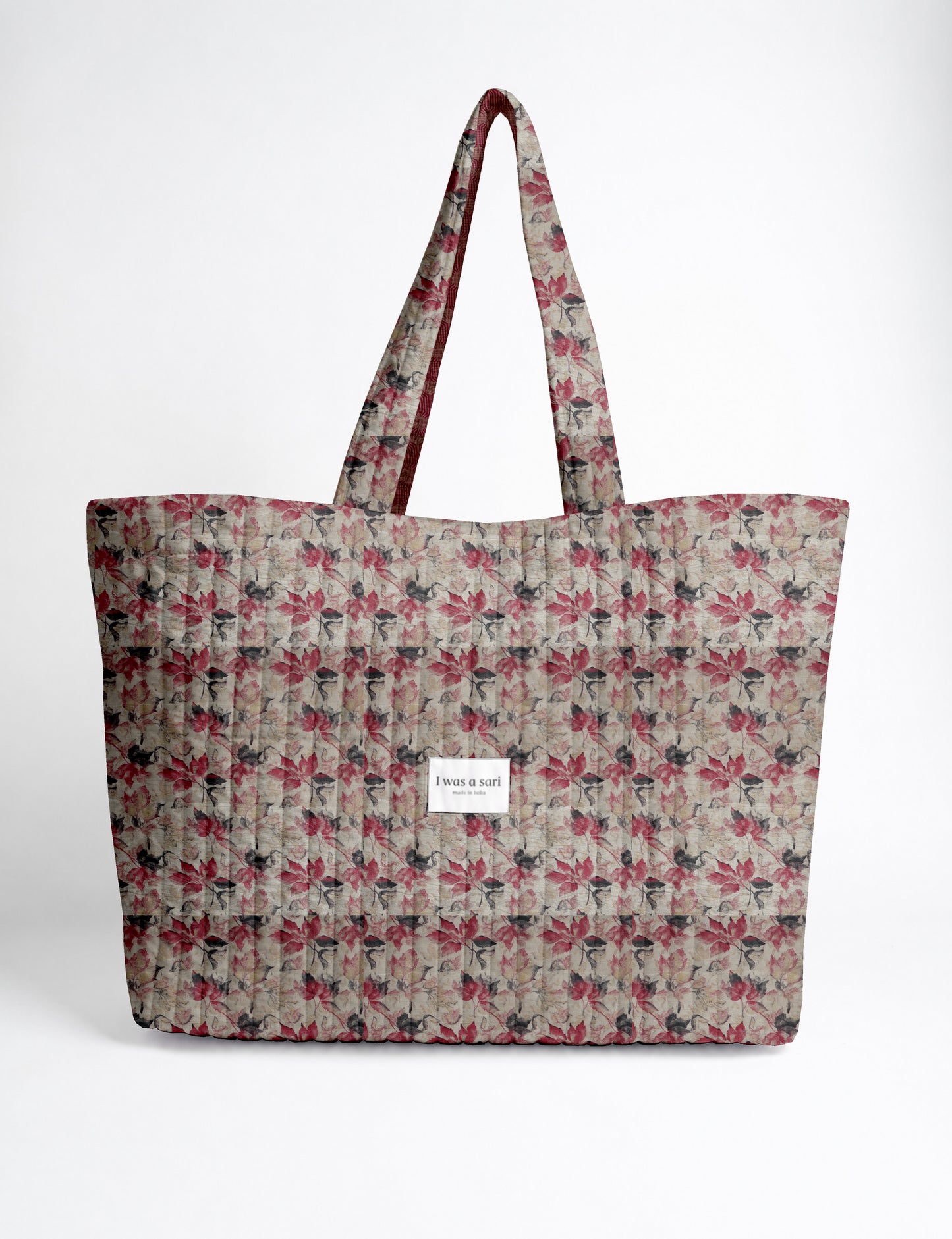 Large quilted beach bag with spacious rectangular design, reinforced shoulder straps, and open-top construction for everyday use and travel.