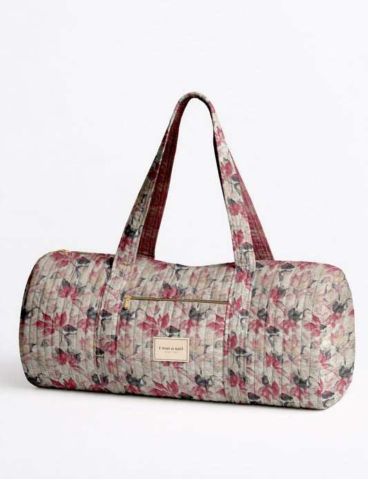 Beige quilted bowling bag with micro floral pattern, front zipper pocket, and dual handles with striped inner lining