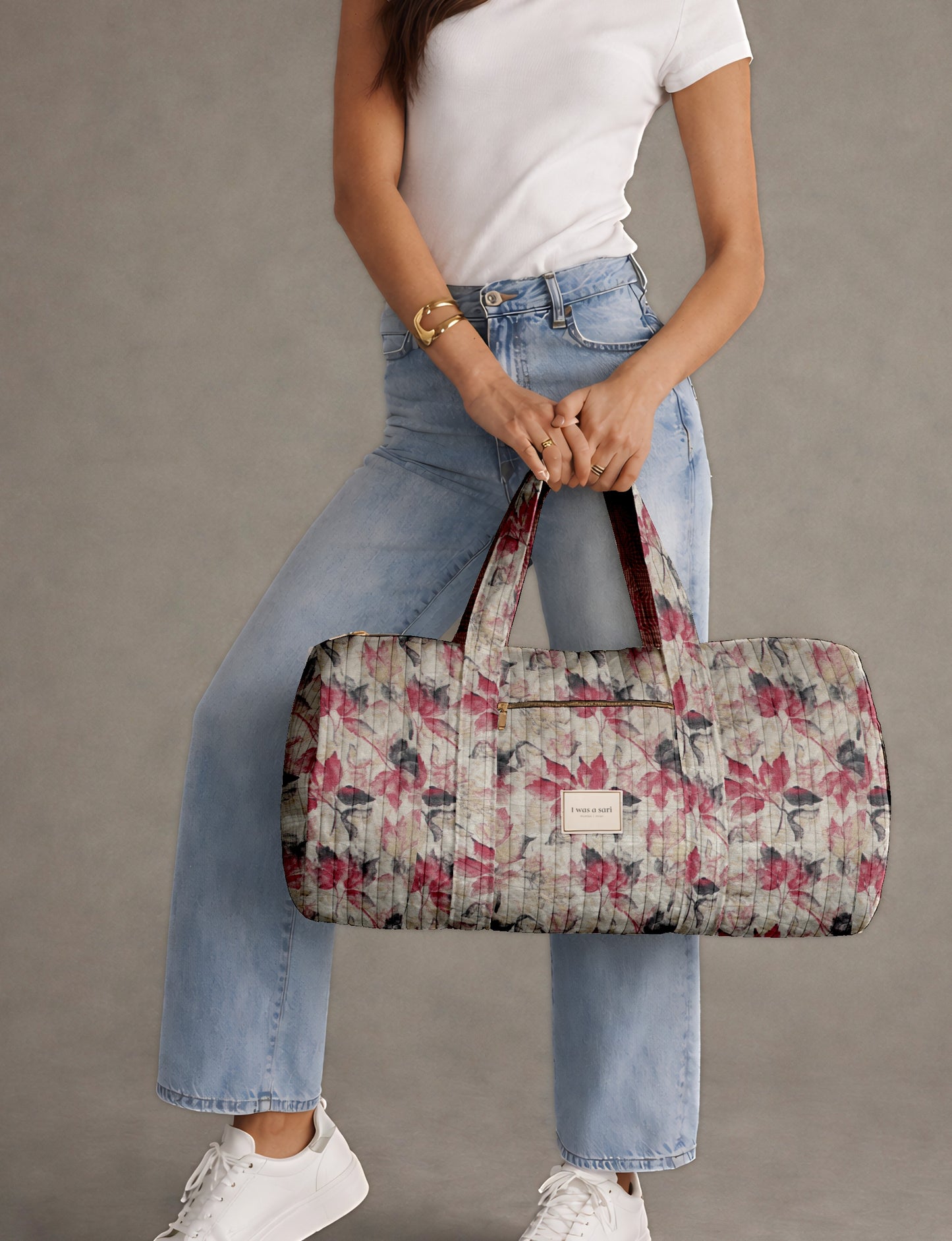 Beige quilted bowling bag with micro floral print exterior and blue geometric patterned interior, open zipper view